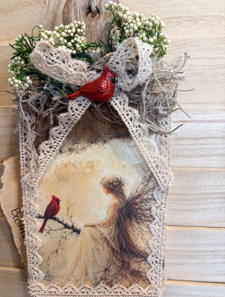 Handmade wooden wall decoration featuring a red cardinal illustration, decorative lace, white babys breath flowers, and a ceramic bird ornament