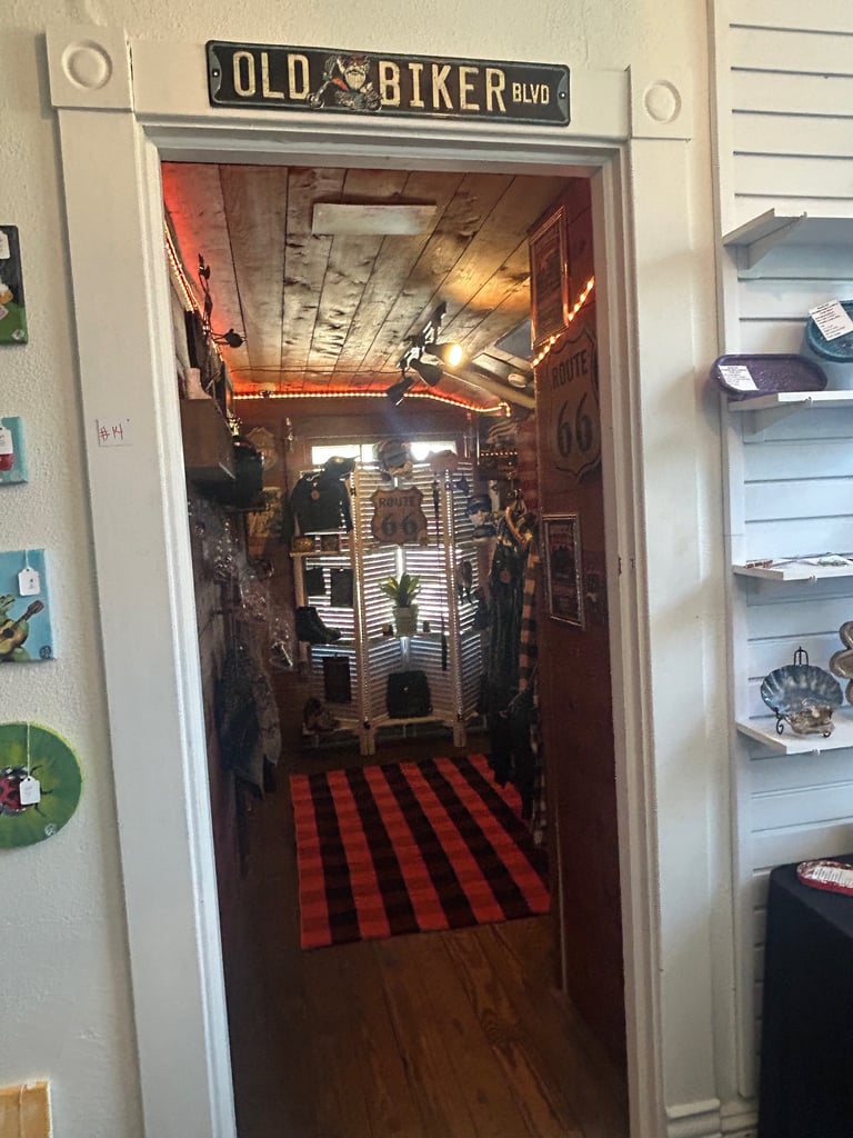 Themed room entrance with Old Biker Blvd sign, neon lighting, and red checkered floor