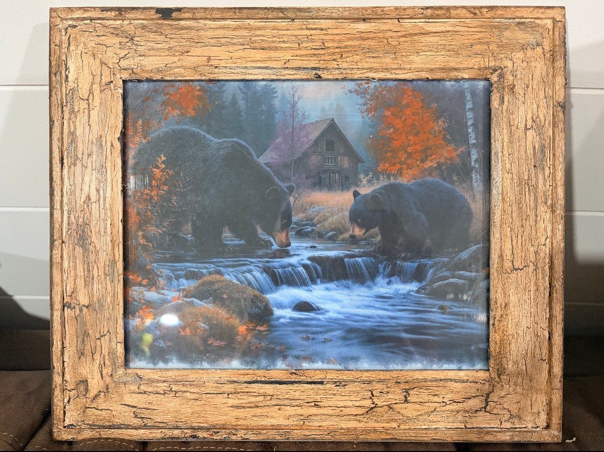 Framed print of bears by a stream with autumn foliage and a cabin in a rustic wooden frame