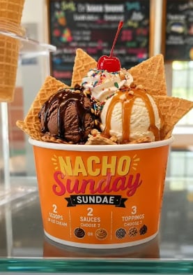 Putter's Nacho Sundae with ice cream, waffle-cone chips, sauces, whipped cream, sprinkles, and a cherry